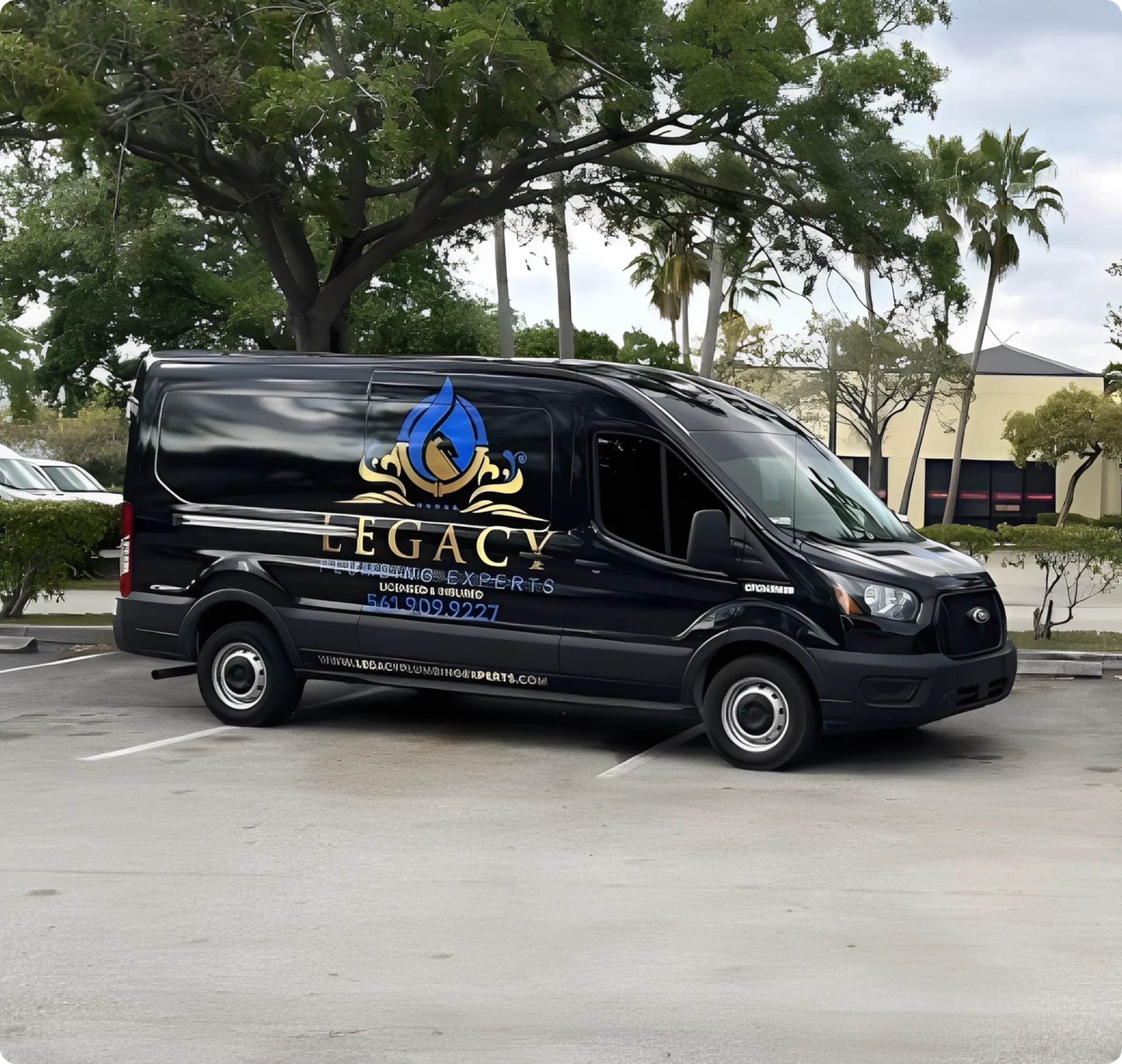 Black Legacy van parked in lot.